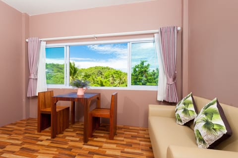 Triple Room with Mountain View | Living area | 32-inch flat-screen TV with cable channels, TV, pay movies