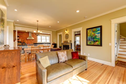 The open main floor space looking from living room to dining room and kitchen.