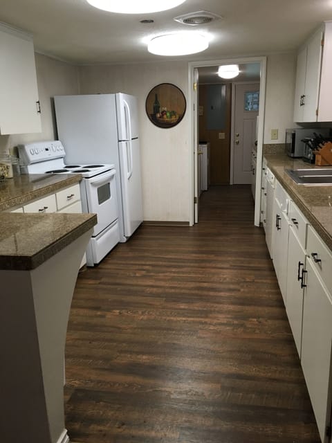 Kitchen area granite countertops plenty of space through the doorway is laundry 