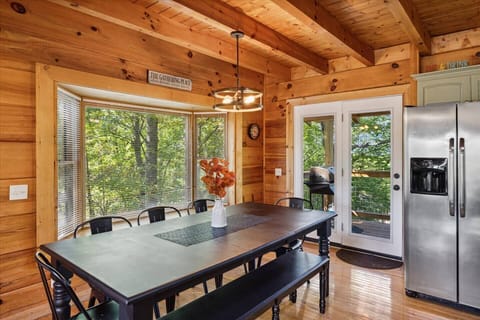 Spacious dining table for 8 plus nearby 3 counter chairs by snack bar in kitchen island.
