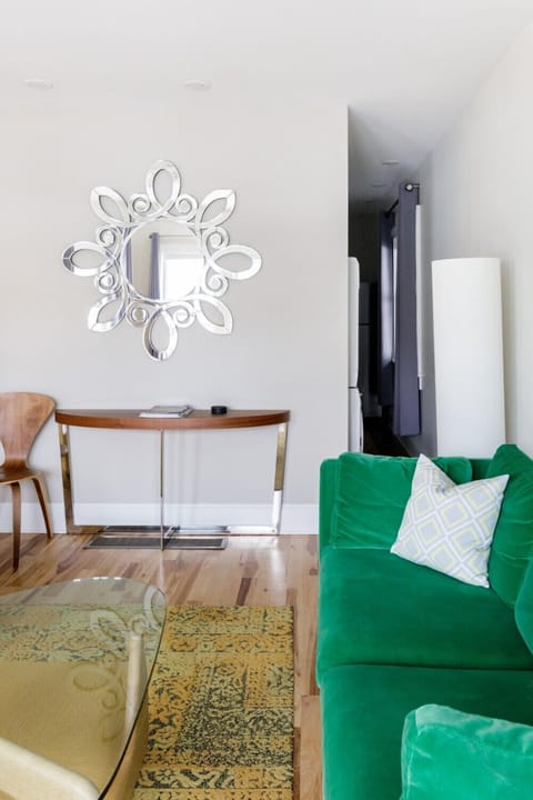 Funky abstract artworks, rich hardwood floors, and modern accents unite for an air of buoyancy within this colorful home.