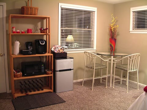 Close up of eating area, refrigerator, and coffee bar