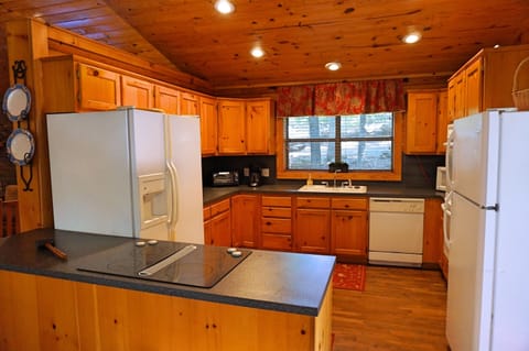 View of kitchen (two refrigerators, double ovens, smooth-surface stove)