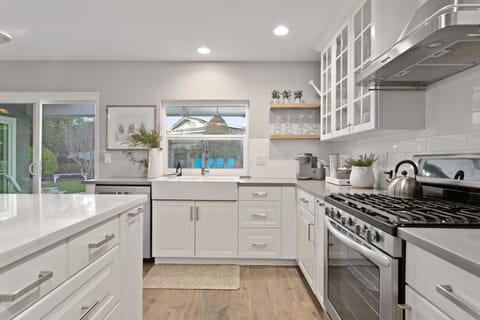 Kitchen with a view of outdoor dining + backyard.
