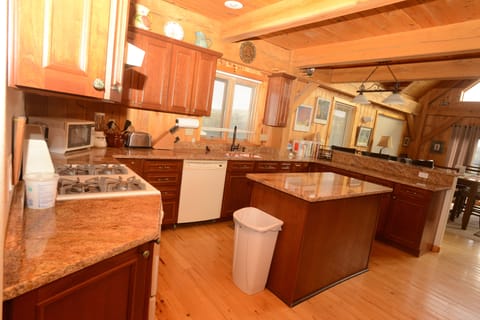 Kitchen: gas stove, copper sink, granite-topped island