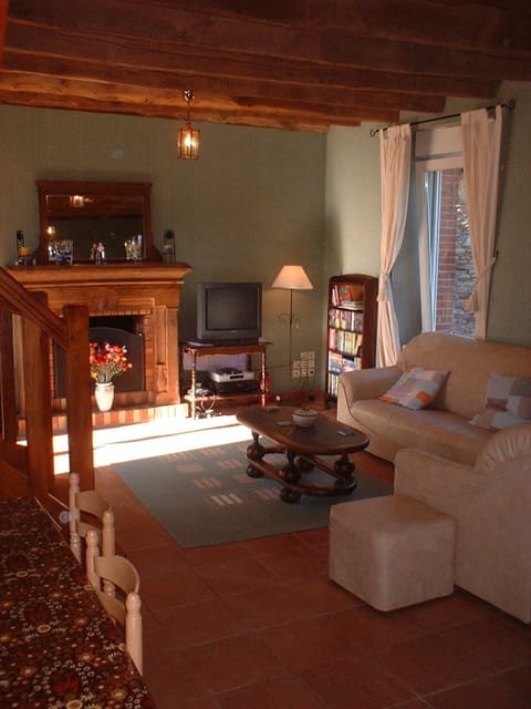 Comfortable lounge with open fireplace, sky TV and oak beamed ceiling