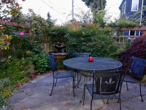 A welcoming trellis fenced courtyard or flagstone patio