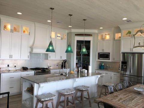 Kitchen showing island with bar stools. 