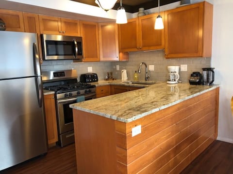 Brand new kitchen with custom cabinets, granite counters and subway tile.