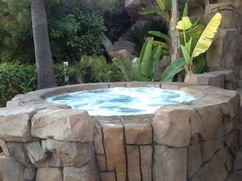 Large hot tub among tropical trees