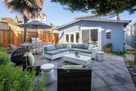 Backyard Area with lounge space, grill, fire pit, and dining table with Umbrella