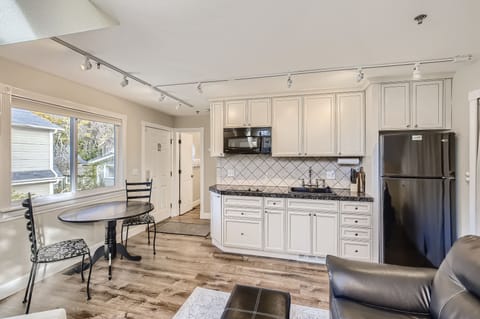 Kitchenette includes 2-burner stovetop, microwave, refrigerator, and more.