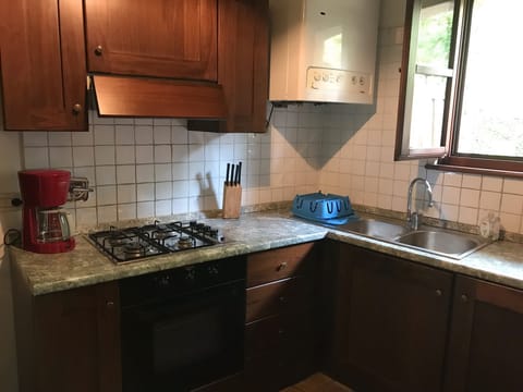 Kitchen. On the other side of the kitchen there is a fridge and other appliances