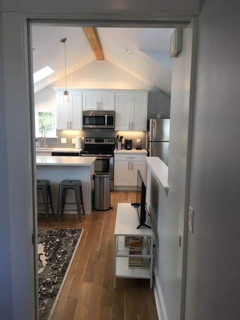 Solid wood pocket door separating the bedroom from the kitchen and living room.