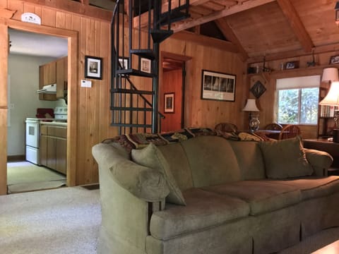 Living area & staircase to loft with vaulted tongue and grove wood ceiling