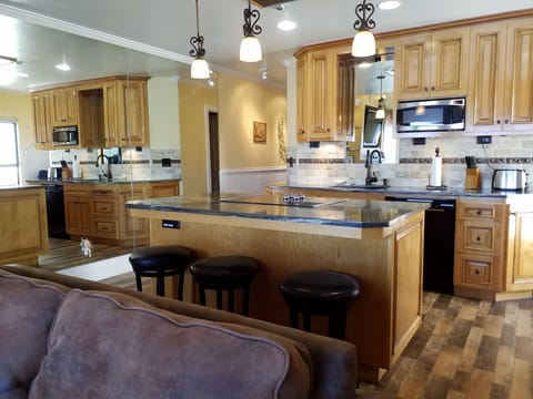 Designer kitchen: granite counters, stainless, applicances, and custom cabinets