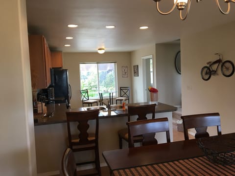 Dining Room looking into fully stocked kitchen with bistro table - mountain view