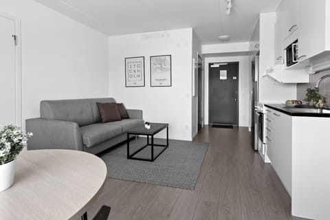 One-bedroom Apartment | Living area | Flat-screen TV