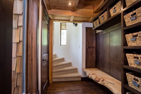 The entryway with cubbies and the spiral staircase to the second floor loft.