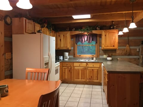 Open concept kitchen well stocked, and 4 bar stools for counter seating. 