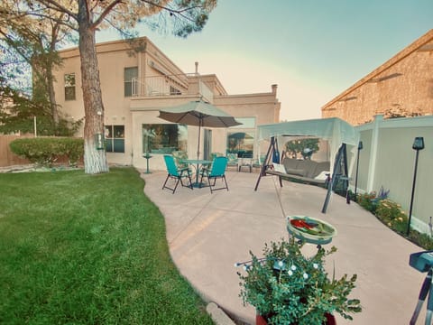 Private fenced back patio, tables, glider, bird feeders, BBQ