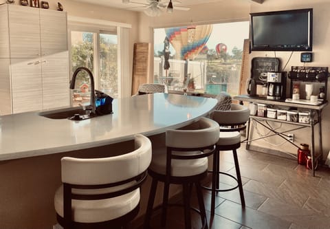 Kitchen with swivel bar stools, coffee bar