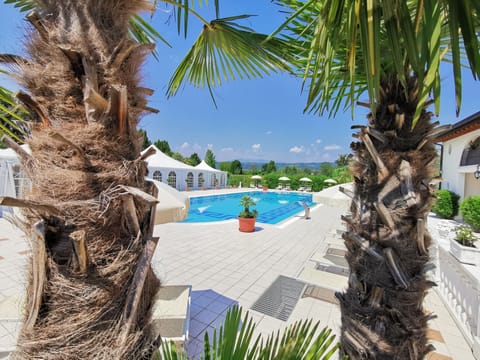 Seasonal outdoor pool, open 7:00 AM to 9:00 PM, pool umbrellas