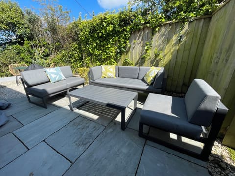 Comfortable seating on garden terrace. And a warm shower for sandy dogs !