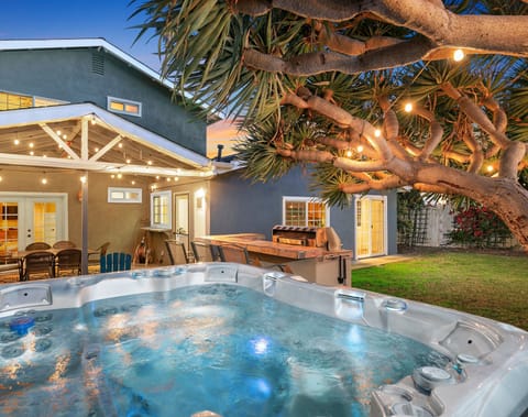 Our beautifully lit backyard, including a clean and spacious jacuzzi.