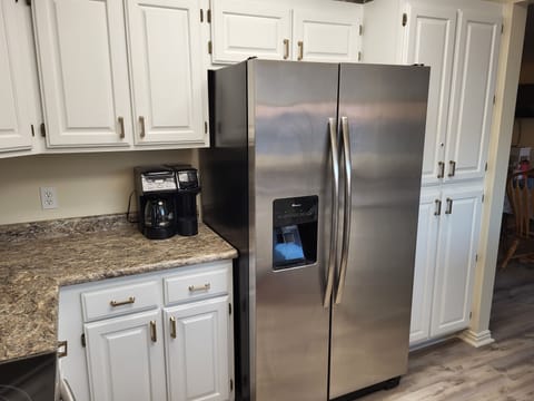 Coffee filters and coffee are on cupboard top shelf; electric kettle below