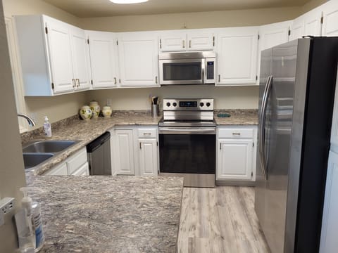 Oven, stove, mircowave, refrigerator; toaster, blender, kettle in bottom cabinet