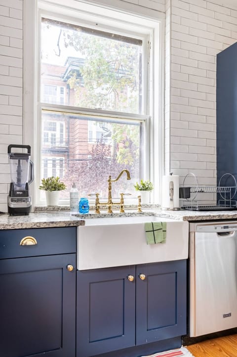 Blender, dishwasher, garbage disposal, refrigerator on view.