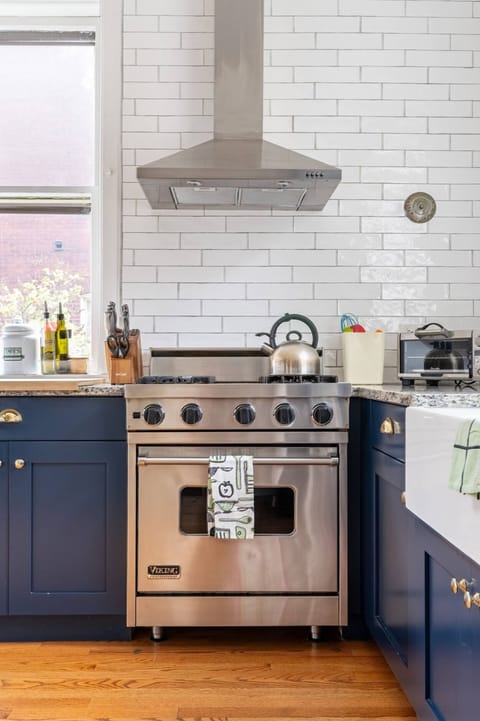 Oven, microwave, toaster, cooking and baking utensils and dishware on hand.