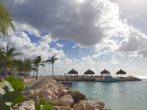 On the beach, white sand, sun loungers, beach umbrellas