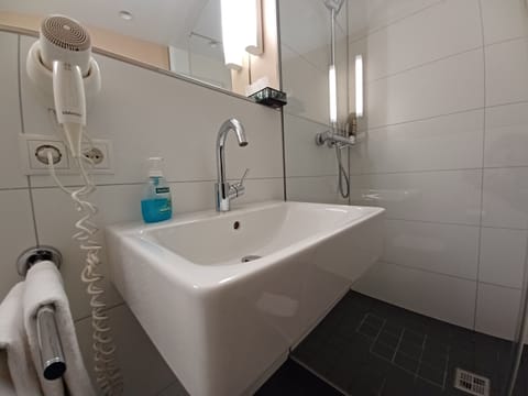 Shower, free toiletries, hair dryer, slippers