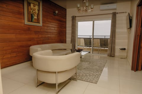 Luxury Suite | Living area | 42-inch flat-screen TV with cable channels, TV