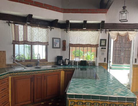 View towards the front patio. A full size dishwasher underneath the countertop.