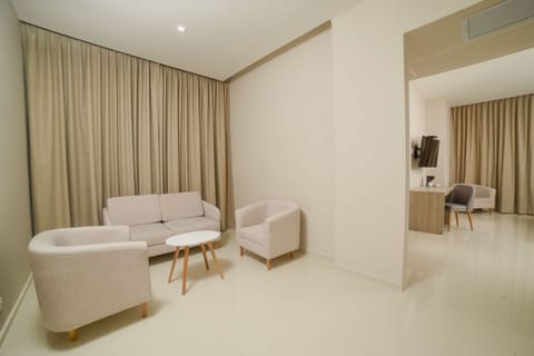 Junior Suite, 1 King Bed, Non Smoking | Living room | 50-inch flat-screen TV with cable channels, TV