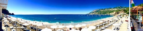 On the beach, black sand, sun loungers, beach umbrellas