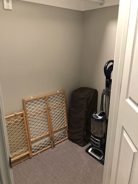 Closet in downstairs master bedroom with child gate and pack n’ play