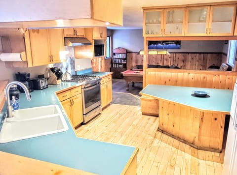 Spacious Custom Kitchen with built-in Seating & Table Opens to All Living Areas.