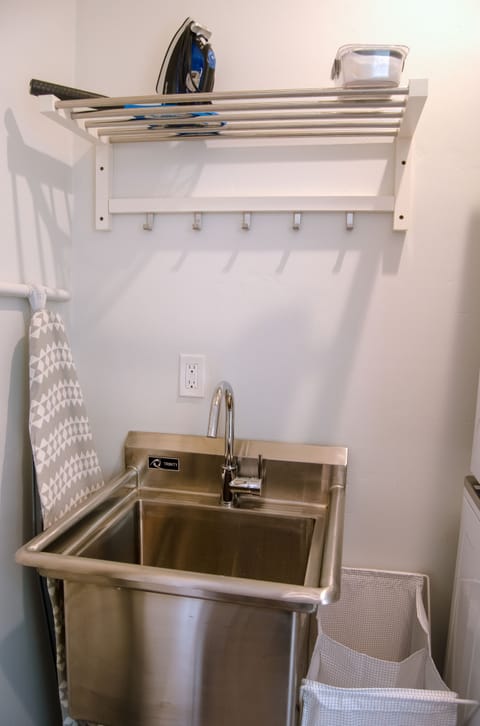 Utility sink located in laundry area. Iron and ironing board available.