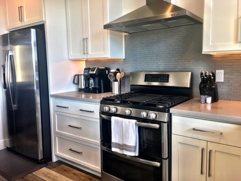 Kitchen area filled cooking supplies, paper goods, coffee, sugar, salt and more.