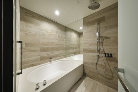 Suite, 1 King Bed | Bathroom | Combined shower/tub, deep soaking tub, eco-friendly toiletries