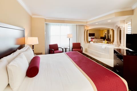Deluxe Jacuzzi Suite | In-room safe, desk, blackout drapes, iron/ironing board