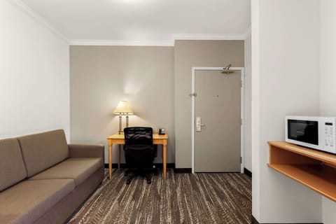 Suite, 2 Queen Beds with Sofa Bed, Refrigerator & Microwave | In-room safe, desk, laptop workspace, blackout drapes