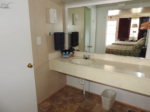 Room, 1 King Bed, Refrigerator | Bathroom sink