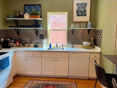 Sunny kitchen with eat in bar opens onto the dining room stocked for your stay.