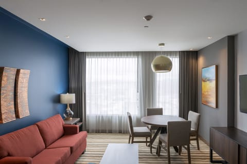 Suite, 1 Bedroom | Living room | 55-inch flat-screen TV with satellite channels, TV