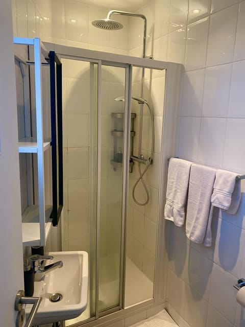 Deluxe Studio | Bathroom | Shower, hair dryer, towels, soap